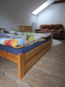 a bed with a wooden frame in a room at Penzión Drieňovkou in Považská Bystrica