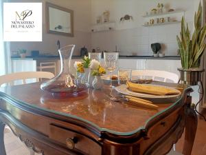 a dining room table with a vase on top of it at Monastero Del Palazzo Casa Vacanze in Spoleto