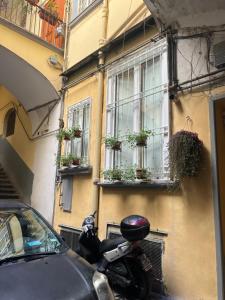a motorcycle parked next to a building with potted plants at Le Casine di Spaccanapoli in Naples