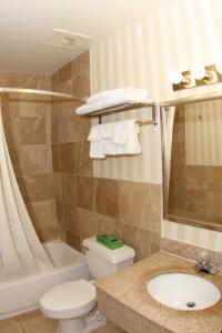 a bathroom with a toilet and a sink and a tub at Super 8 by Wyndham Kutztown/Allentown Area in Kutztown