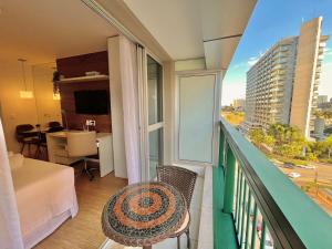 einen Balkon mit einem Bett und ein Zimmer mit Aussicht in der Unterkunft BSB Stay Flats Particulares - SHN in Brasilia