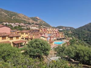 a village on the side of a mountain at La Perla e le Conchiglie Tanca Piras vista mare in Nebida