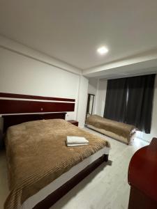 a hotel room with two beds and a window at D&M Apartments in Struga