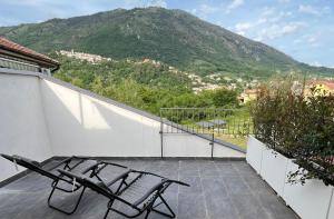 two chairs sitting on a balcony with a mountain at Alla Posta Matrimoniale Relax in Posta Fibreno