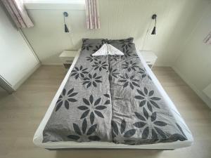 a bed with a gray comforter in a room at Åndalsnes Luxury Stay - Full Apartment in Åndalsnes