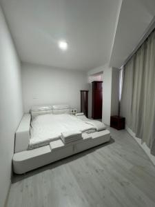 a white bedroom with a large bed in it at M&D Apartment in Struga