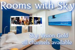 a room with a bed with pictures on the wall at L'Alba Hotel in Marina di Pietrasanta