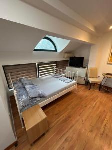 a large bed in a room with a window at Apartments Iva in Kragujevac