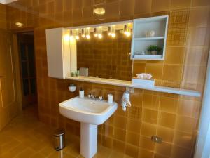 a bathroom with a sink and a mirror at Casa alla Fontana in Serravalle allʼAdige +31 photos
