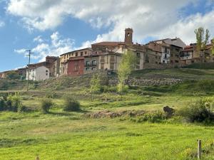 a large building on top of a green field at Casa ELENA i MARTA , Valdelinares in Valdelinares