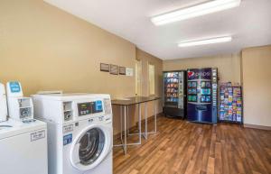 a laundry room with two vending machines and a washer at Extended Stay America Select Suites - Columbia - Gateway Drive in Columbia