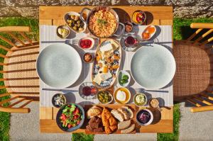 a table with plates of food on top of it at Meruno Alaçatı in Çeşme