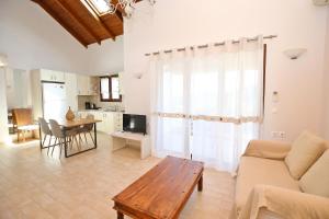 a living room with a couch and a table at Kores Villas in Nydri