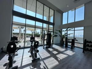 a gym with treadmills and exercise equipment in a building at AshriHH/ ModernStudio in Jadaf in Dubai