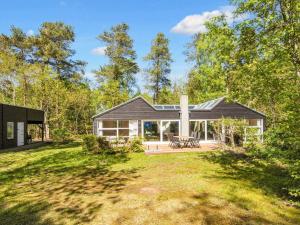 a house in the woods with a large yard at 8 person holiday home in Glesborg-By Traum in Fjellerup