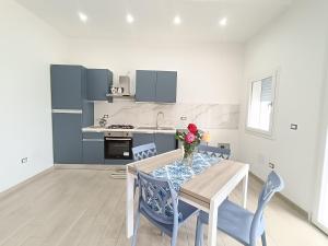 a kitchen with a table with a vase of flowers on it at Casa di Hermes in Pizzo