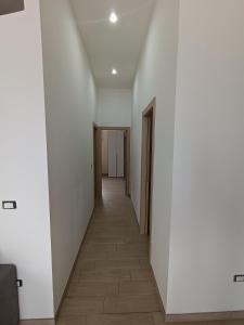 a hallway with white walls and a tile floor at Casa di Hermes in Pizzo