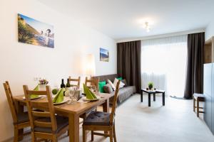 a dining room and living room with a table and chairs at Haus Luigi in Sölden