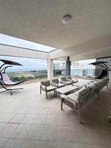 a room with benches and chairs on a balcony at Christale Rooms in Năvodari