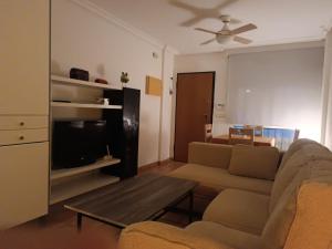 a living room with a couch and a coffee table at Adosado mediterráneo in Orihuela