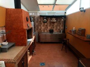 a large kitchen with a counter and a stove at Adosado mediterráneo in Orihuela Costa