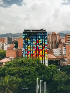 a tall building with colorful windows in a city at Indie Universe Creative Hotel in Medellín