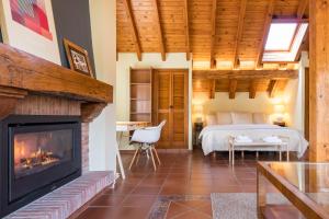 a bedroom with a fireplace and a bed in a room at Casa Velasco in Esles