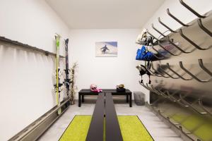a room with a table and skis on a wall at Haus Luigi in Sölden