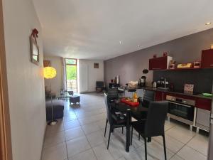 a kitchen and dining room with a table and chairs at Charmante maison avec jardin, au cœur du Berry, proche rivière et randonnées - FR-1-591-57 in Chasseneuil