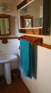 a bathroom with a sink and a blue towel at UrbanEscape in Centurion +90 photos