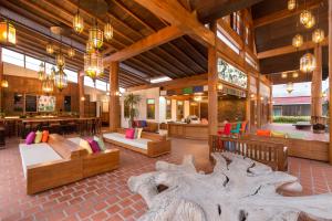 a large lobby with a large tree stump in the middle at Naina Resort & Spa - SHA Extra Plus in Patong Beach