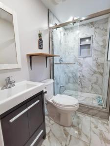 a bathroom with a toilet and a sink and a shower at Myriad Fins Cottage and Marina in Kawartha Lakes +64 photos