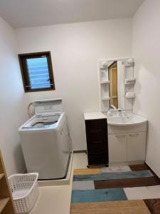 a bathroom with a sink and a washing machine at N's Home - 南名古屋駅一軒家 - 8 in Nagoya