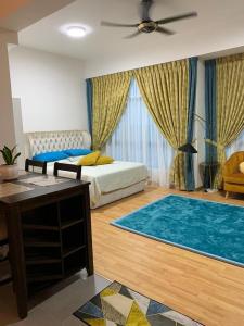 a bedroom with two beds and a blue rug at Kuantan City 188 in Kuantan