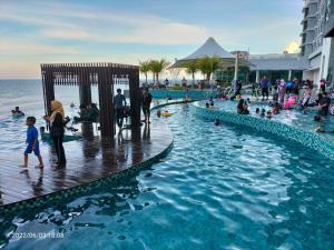 a group of people in a swimming pool at a resort at Kuantan City 188 in Kuantan +2 photos