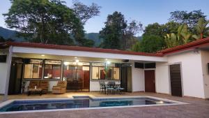 a house with a swimming pool in front of it at Casa pacific vista in Ojochal