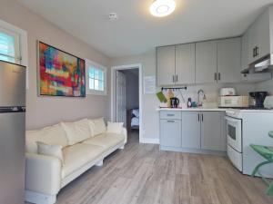 a living room with a couch and a kitchen at Myriad Fins Cottage and Marina in Kawartha Lakes