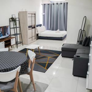 a living room with a table and a couch at KLIA AIRPORT HOMESTAY in Sepang