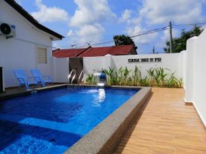 a swimming pool in front of a house at casa261 HOMESTAY PD in Port Dickson +56 photos