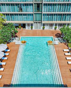 a large swimming pool in front of a building at Hyatt Regency Phnom Penh in Phnom Penh