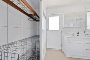 a bathroom with a glass walk in shower next to a sink at Sponars Onshore - 2BR Apartment l Pet-Friendly l WiFi l Air-Con l Fenced Backyard in Jindabyne +10 photos