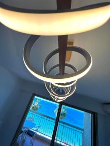 a chandelier hanging from a ceiling with a window at Juan les Pins - Sea View - 4 people - Parking in Juan-les-Pins