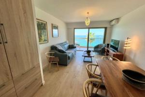 a living room with a couch and a table at Juan les Pins - Sea View - 4 people - Parking in Juan-les-Pins