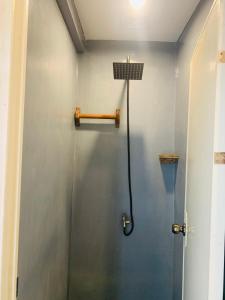 a shower stall in a bathroom with a shower at Jaydy hostel in General Luna +43 photos