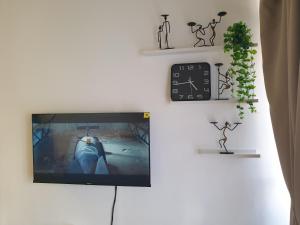 a flat screen tv hanging on a wall at 1Bedroom Urban Oasis Retreat in Melaka