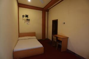 カトゥナーヤカにあるCinnamon Airport Residenciesの小さなベッドルーム(ベッド1台、デスク付)