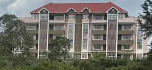 a large building with a red roof at Stylish 2 bedroom in Kitale Fully Furnished in Kitale