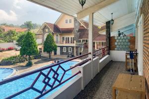 a view from the balcony of a house with a swimming pool at Urbanview Hotel Villa Q Gisting by RedDoorz in Banjarnegeri +20 photos