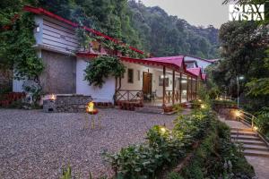 a house in the mountains with lights in the yard at StayVista at Edwinstowe House with Heater, Bonfire & BBQ Grill in Nainital