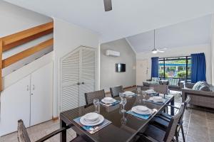 a dining room with a table and chairs at Cable Beachside Apartments in Broome